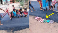 Đám trẻ tự cởi giày đi chân đất vì sợ làm bẩn con đường mới trải nhựa