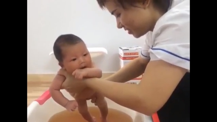 Nữ y tá hướng dẫn tắm cho trẻ sơ sinh đúng chuẩn