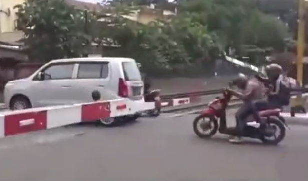 Cô gái suýt gãy cổ vì bạn trai cố lao qua thanh chắn tàu hỏa