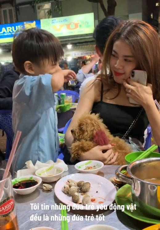 Cay mắt hình ảnh cậu bé bán hàng rong âu yếm chú cún của khách