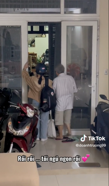Thấy bố tặng hoa cho mẹ, cô bé lúi cúi rồi vui vẻ vì mình cũng có phần